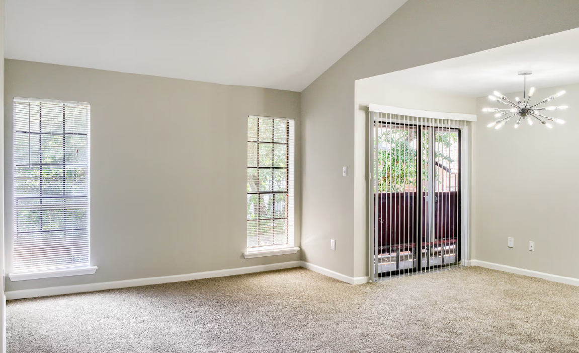 Spacious apartment interior with natural light at Chateau Carmel New Orleans