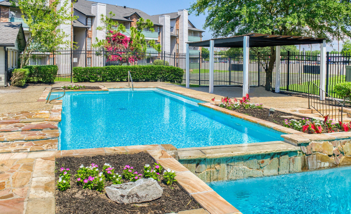 Swimming pool with tropical landscaping Chateau Carmel Little Woods apartments