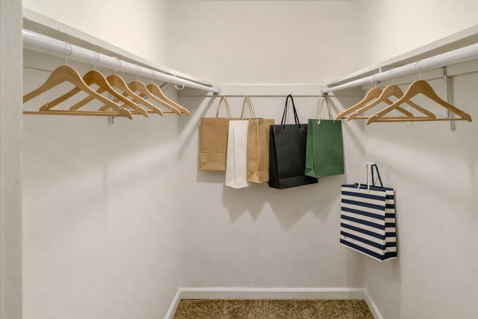 Walk-in closet with hanging storage at Chateau Carmel Apartments in New Orleans, LA